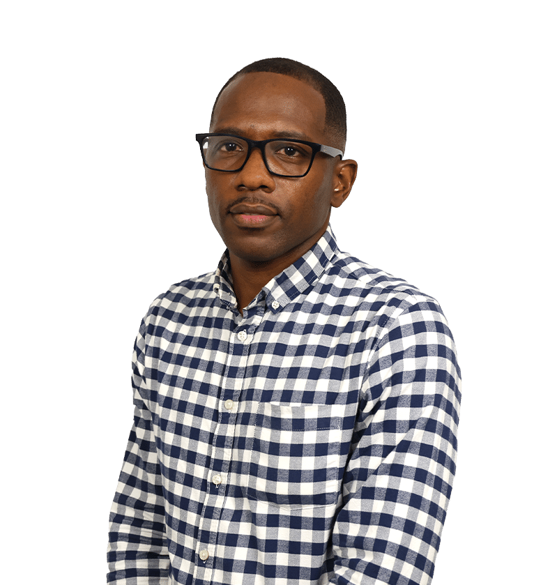 Portrait of a man wearing black glasses and a navy white checkered shirt, looking at the camera.